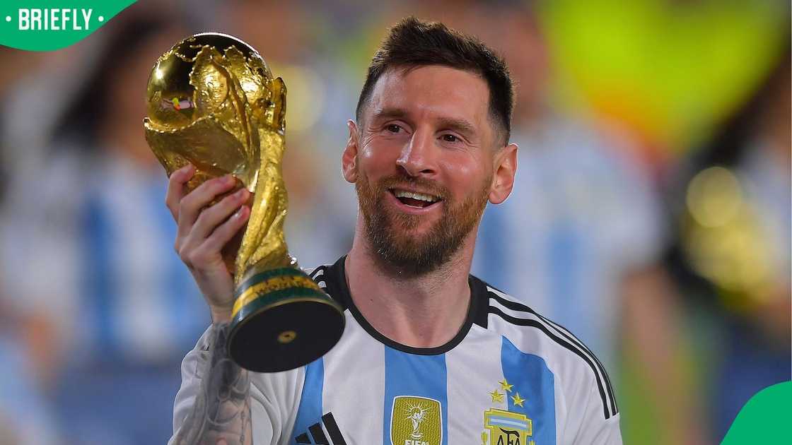 Lionel Messi of Argentina celebrates with the FIFA World Cup trophy