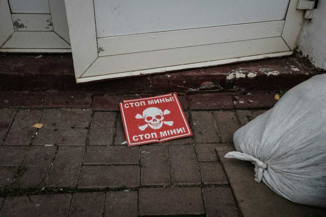 A mine sign outside the destroyed railway building at Kozacha Lopan, a retaken town in the eastern Ukrainian border region of Kharkiv A mine sign outside the destroyed railway building at Kozacha Lopan, a retaken town in the eastern Ukrainian border region of Kharkiv