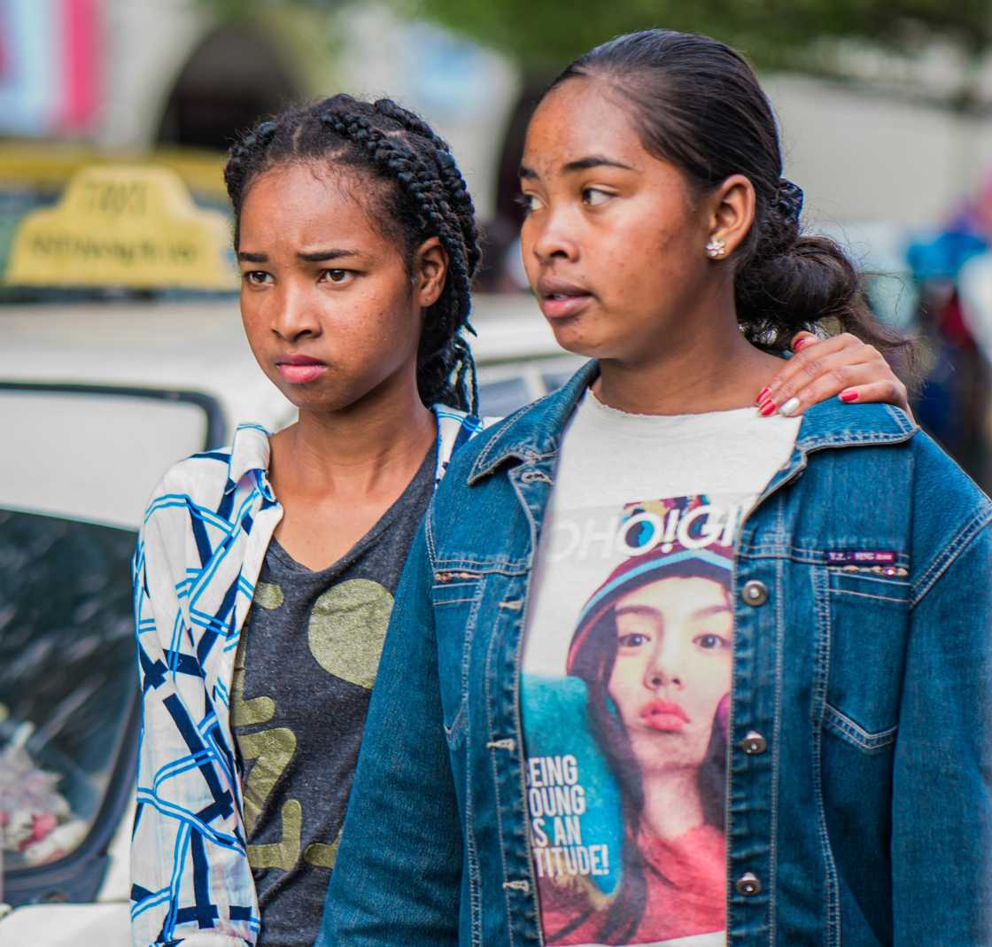 Two ladies walking together; the young looking distressed