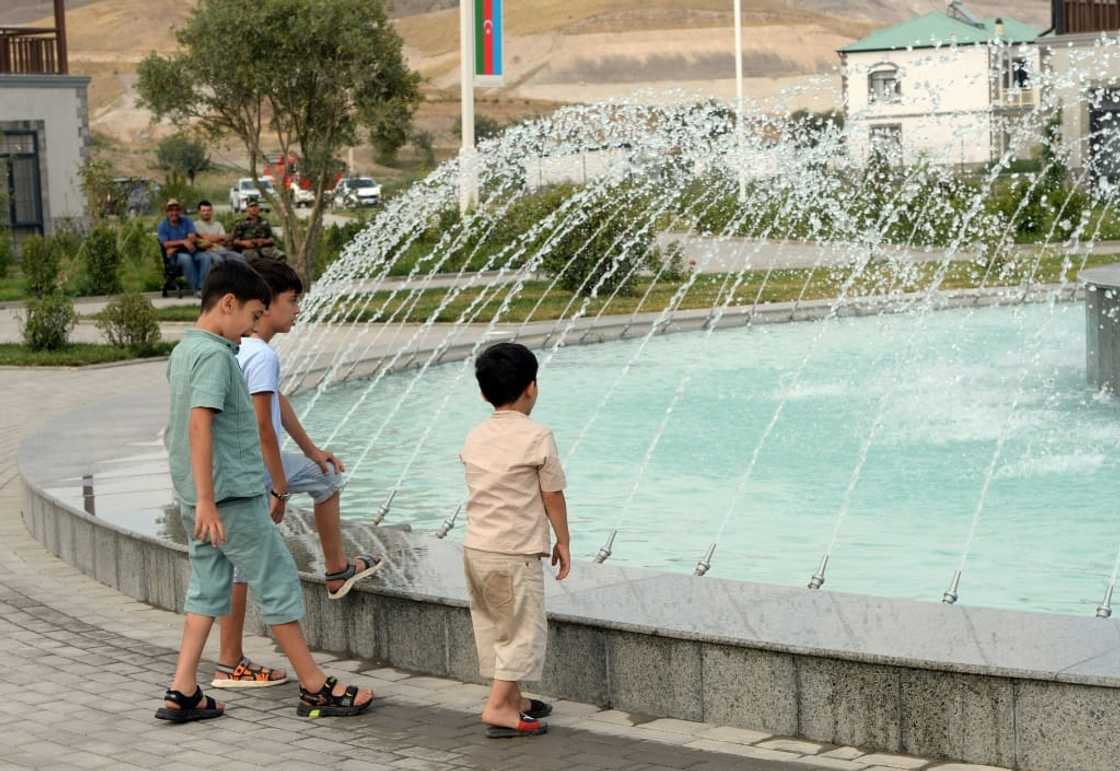 Emotions ran high as repatriates rediscovered Agally's central square, where a new fountain sparkled Emotions ran high as repatriates rediscovered Agally's central square, where a new fountain sparkled