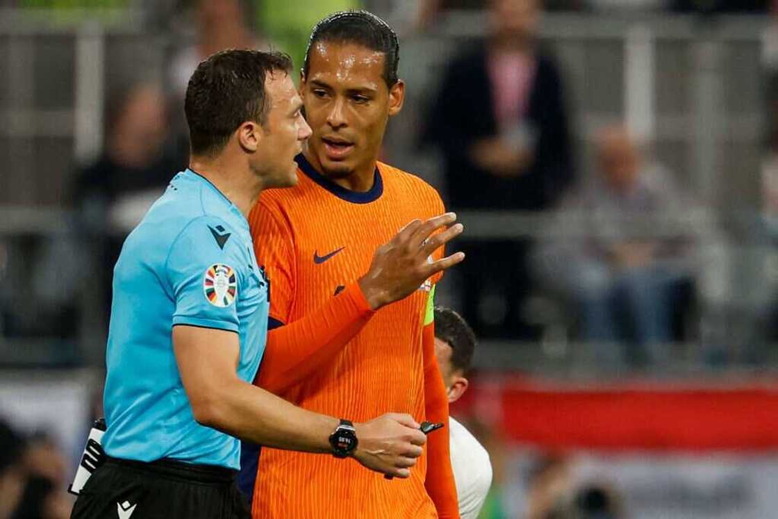 Virgil Van Dijk talks to Felix Zwayer during Euro 2024 semi-final between the Netherlands and England