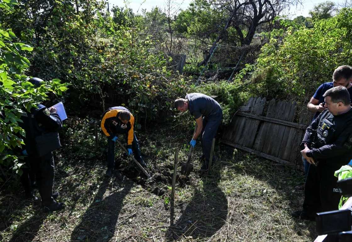 Police and a team from the Kharkiv region's prosecutors office exhumed two bodies Police and a team from the Kharkiv region's prosecutors office exhumed two bodies