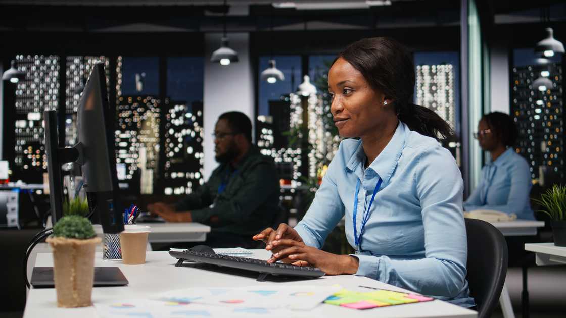 People work in an open-plan office at night. People work in an open-plan office at night.