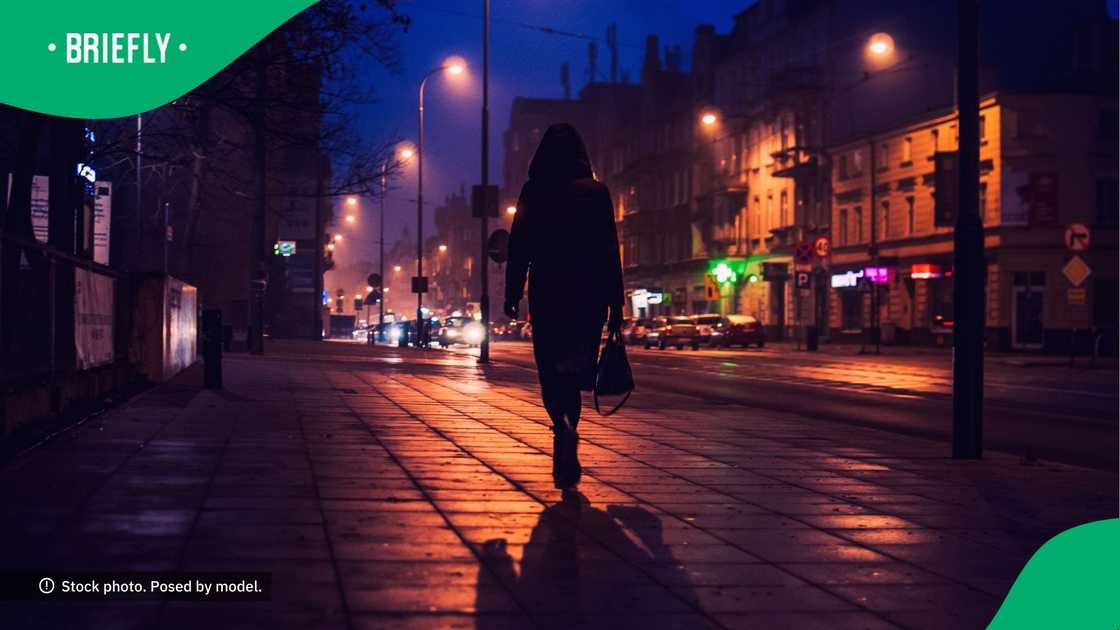 Woman walking alone at night. Woman walking alone at night.