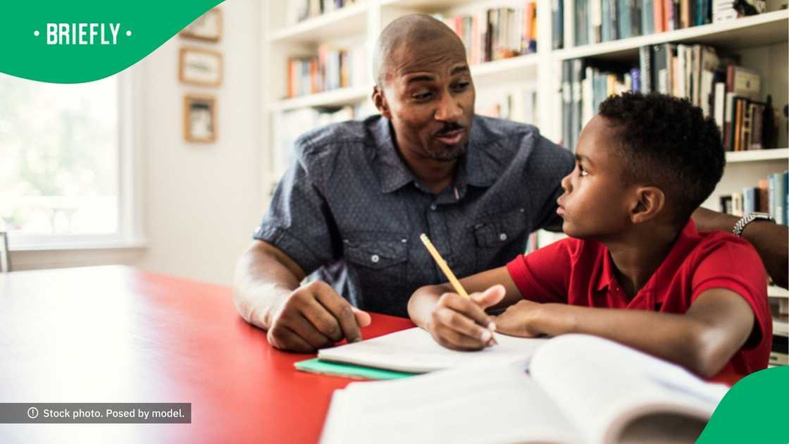 A man's patience wore thin as he helped a kid with homework. A man's patience wore thin as he helped a kid with homework.