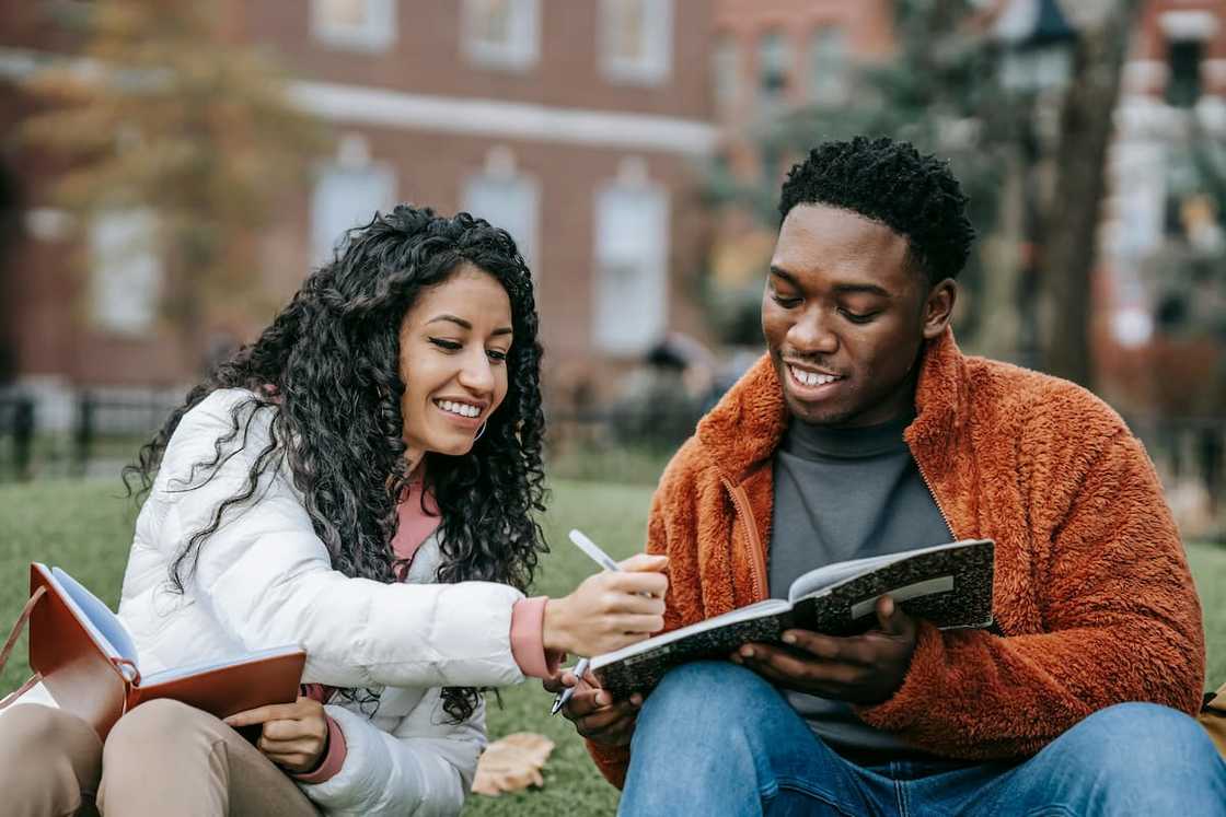 A male and female student doing an assignment together