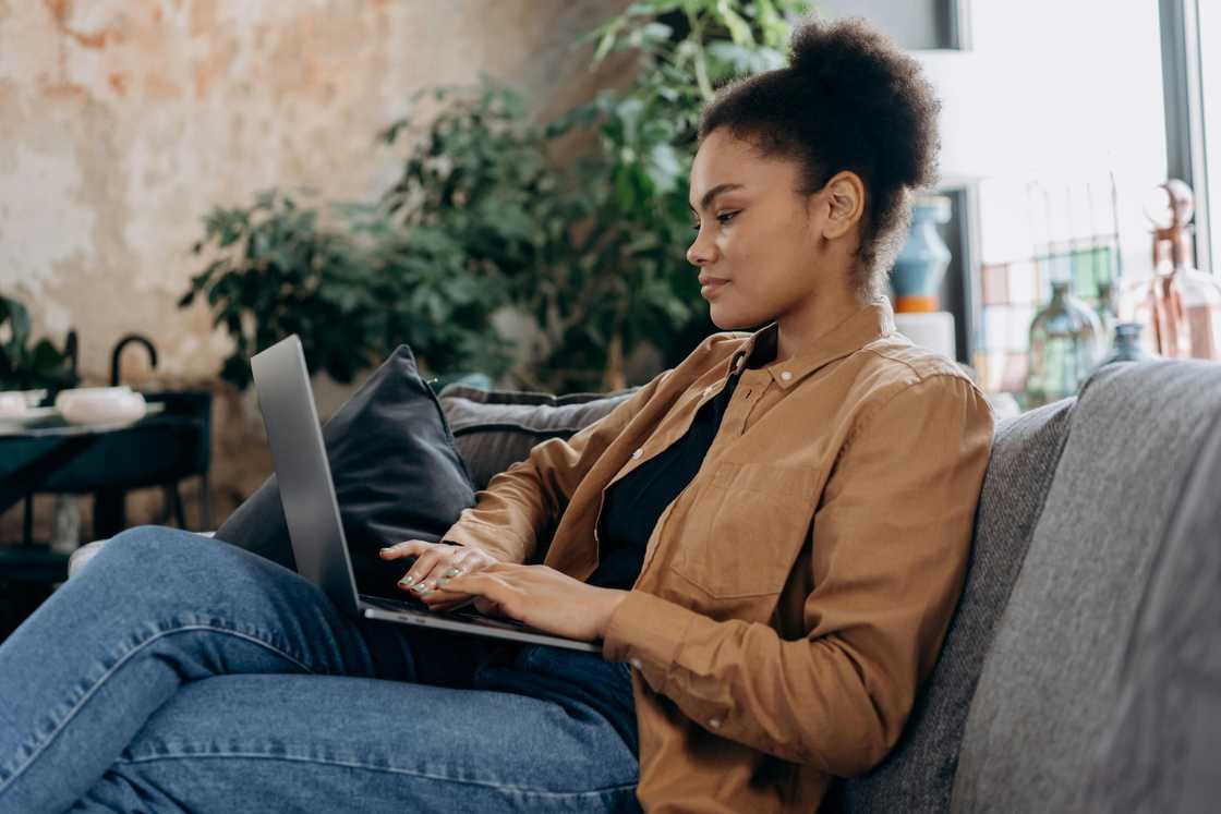 A woman using a laptop.