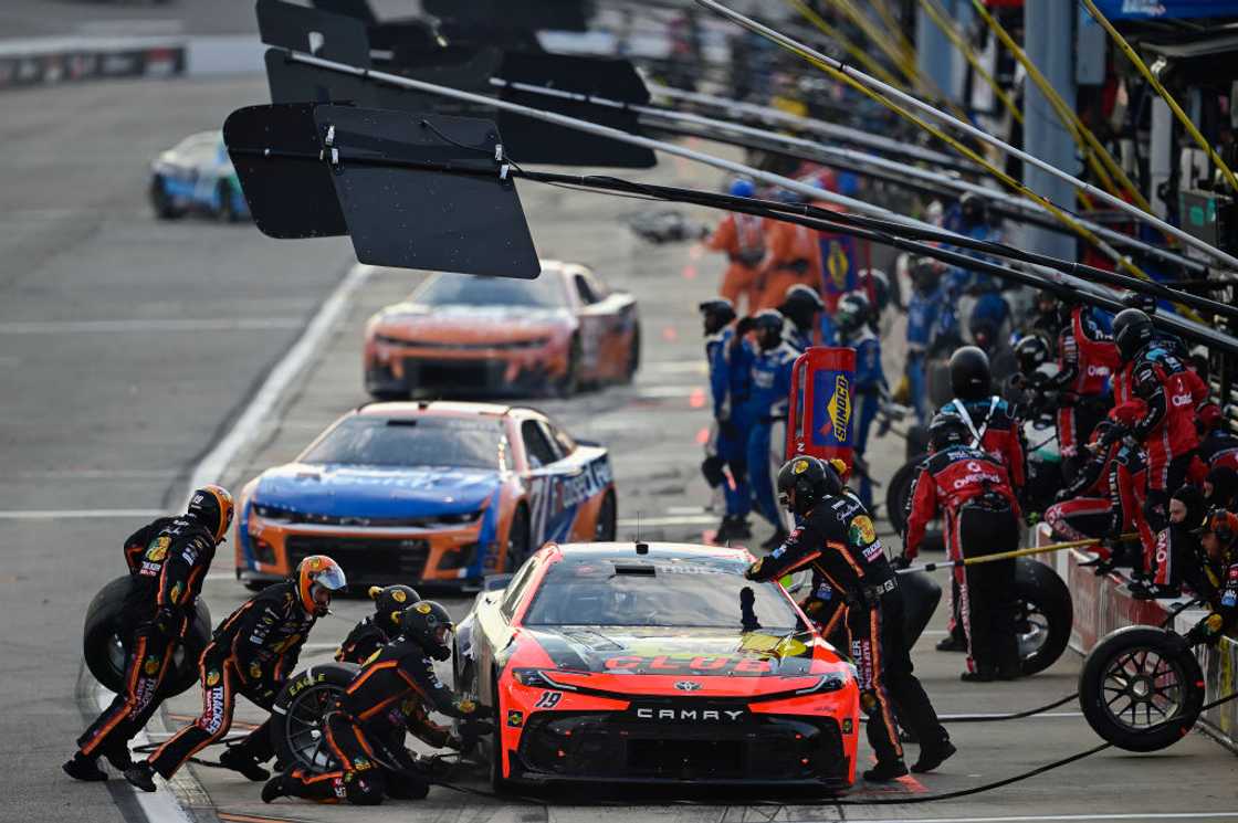 Pit crew working on Martin Truex Jr.'s race car Pit crew working on Martin Truex Jr.'s race car