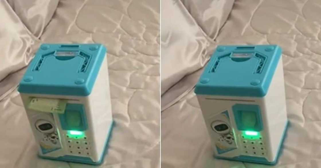 Woman shows of sons electronic piggy bank Woman shows of sons electronic piggy bank