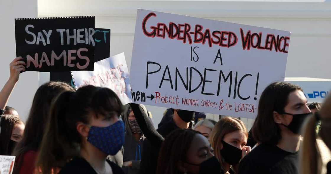 Protesters hold signs and shout slogans as they take part in a march against gender based violence and in solidarity with women who have been subject to violence and in memory of those who have been killed Protesters hold signs and shout slogans as they take part in a march against gender based violence and in solidarity with women who have been subject to violence and in memory of those who have been killed