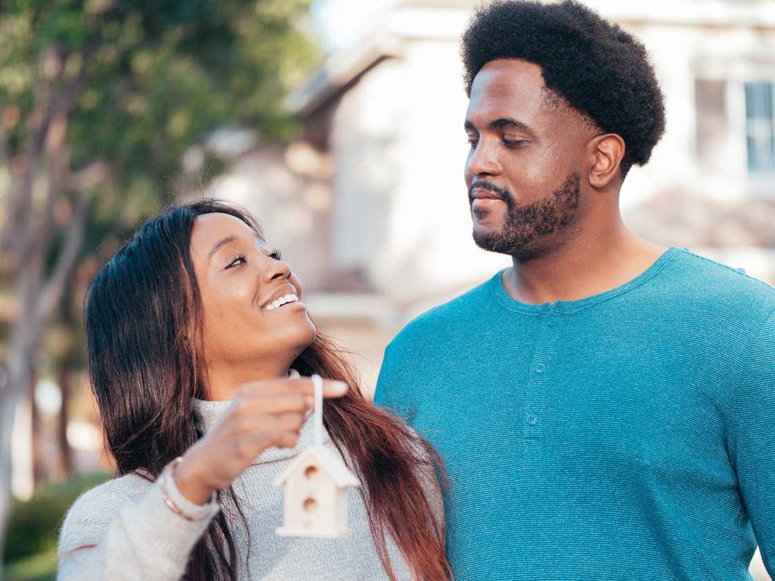 A couple smile and talk outdoors.