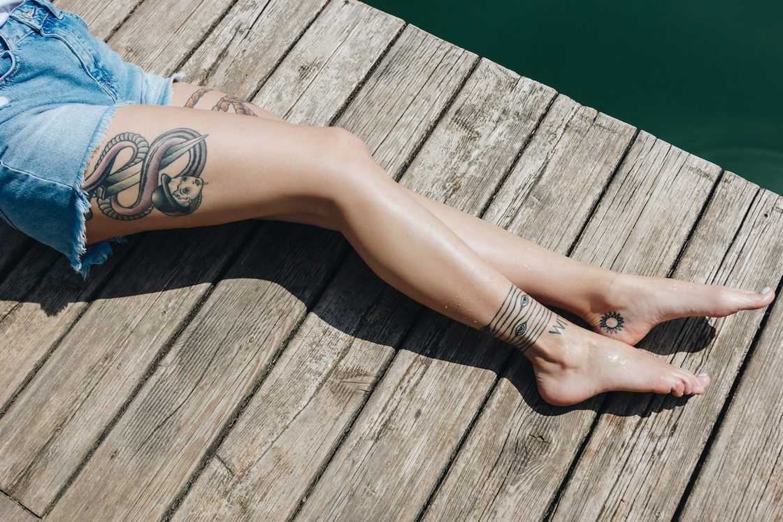 Female side thigh tattoos