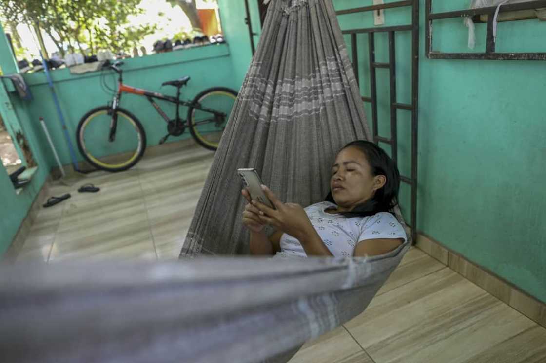 Cristina Quirino Mariano, a member of the Ticuna people, writes a message using the Linklado app in Manaus, northern Brazil