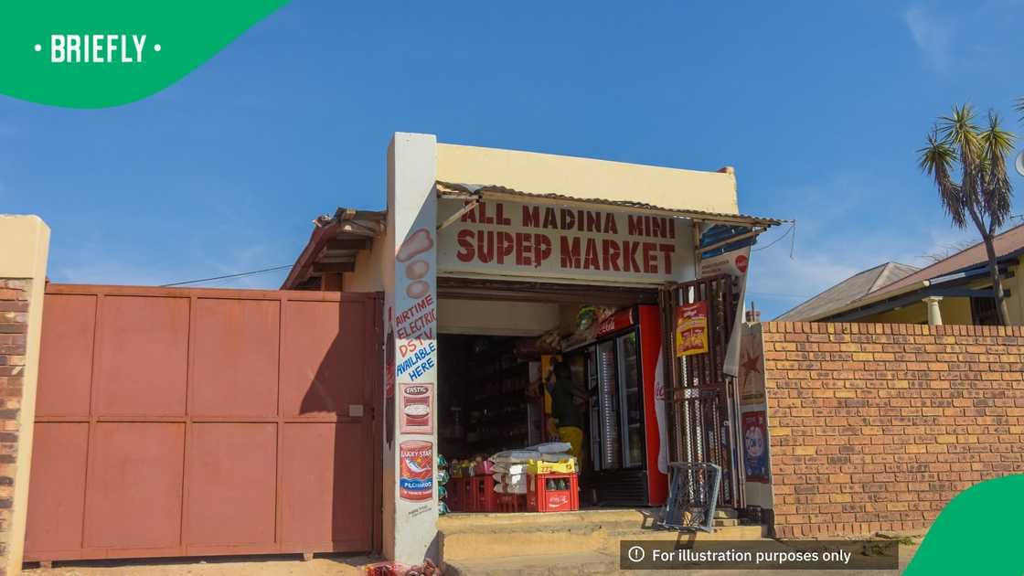 Johannesburg , Gauteng / South Africa -August 02 2018 : small Spaza African shop, showing variety of goods for sale, hot daytime, blue sky in the background, man inside the store, horizontal shot Johannesburg , Gauteng / South Africa -August 02 2018 : small Spaza African shop, showing variety of goods for sale, hot daytime, blue sky in the background, man inside the store, horizontal shot