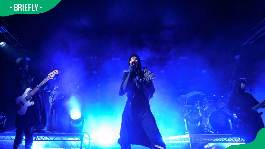 Sleep Token members performing on stage Sleep Token members performing on stage