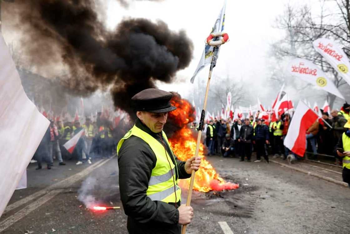 Blowing horns, throwing smoke bombs and firecrackers and lighting fires, the farmers gathered outside the prime minister's office