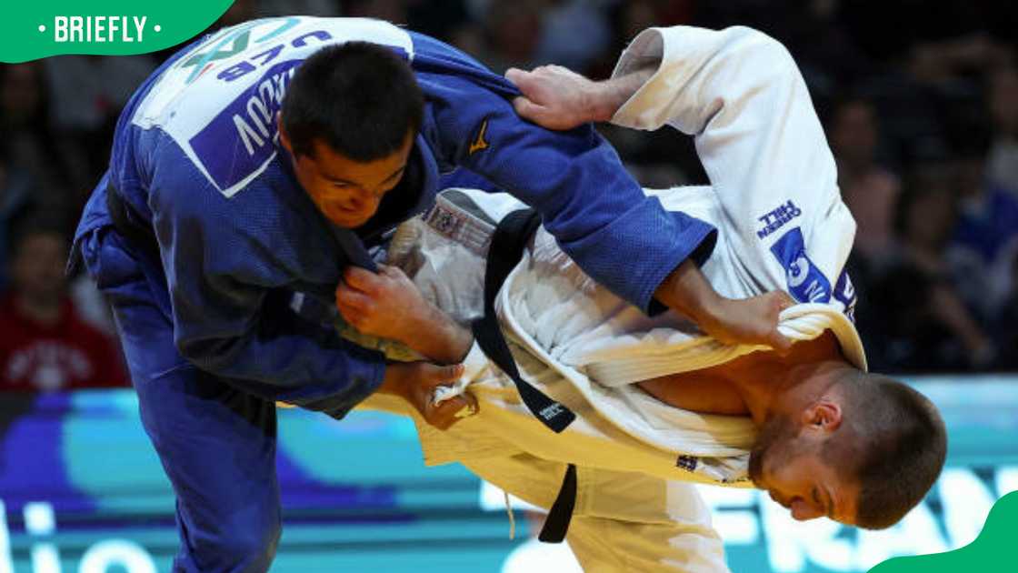 Kosovo's Akil Gjakova (white) competing against Uzbekistan's Shakhram Ahadov (blue)