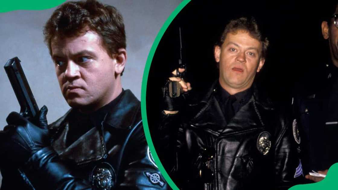 David Graf holds a gun up in the set of Police Academy David Graf holds a gun up in the set of Police Academy