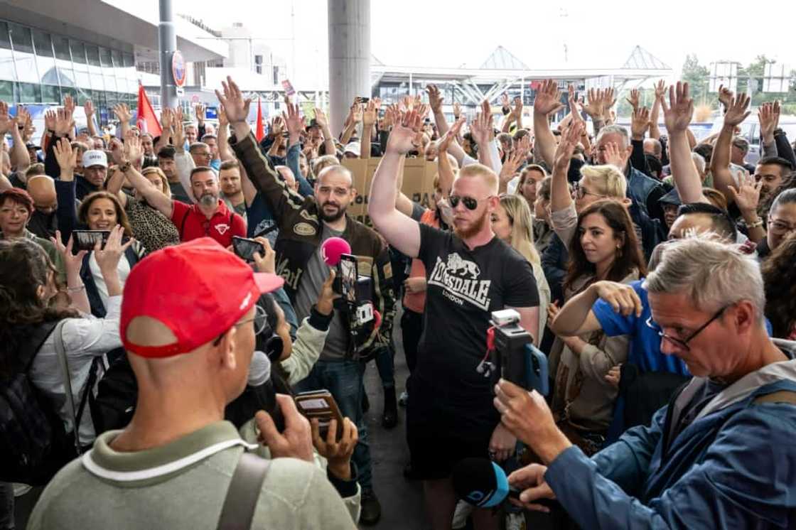 Airport workers voted to extend their strike, originally due to last for four hours on Friday, through Saturday Airport workers voted to extend their strike, originally due to last for four hours on Friday, through Saturday