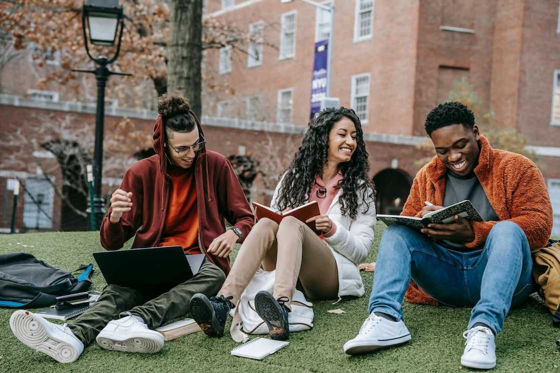 Cheerful students with books at the university