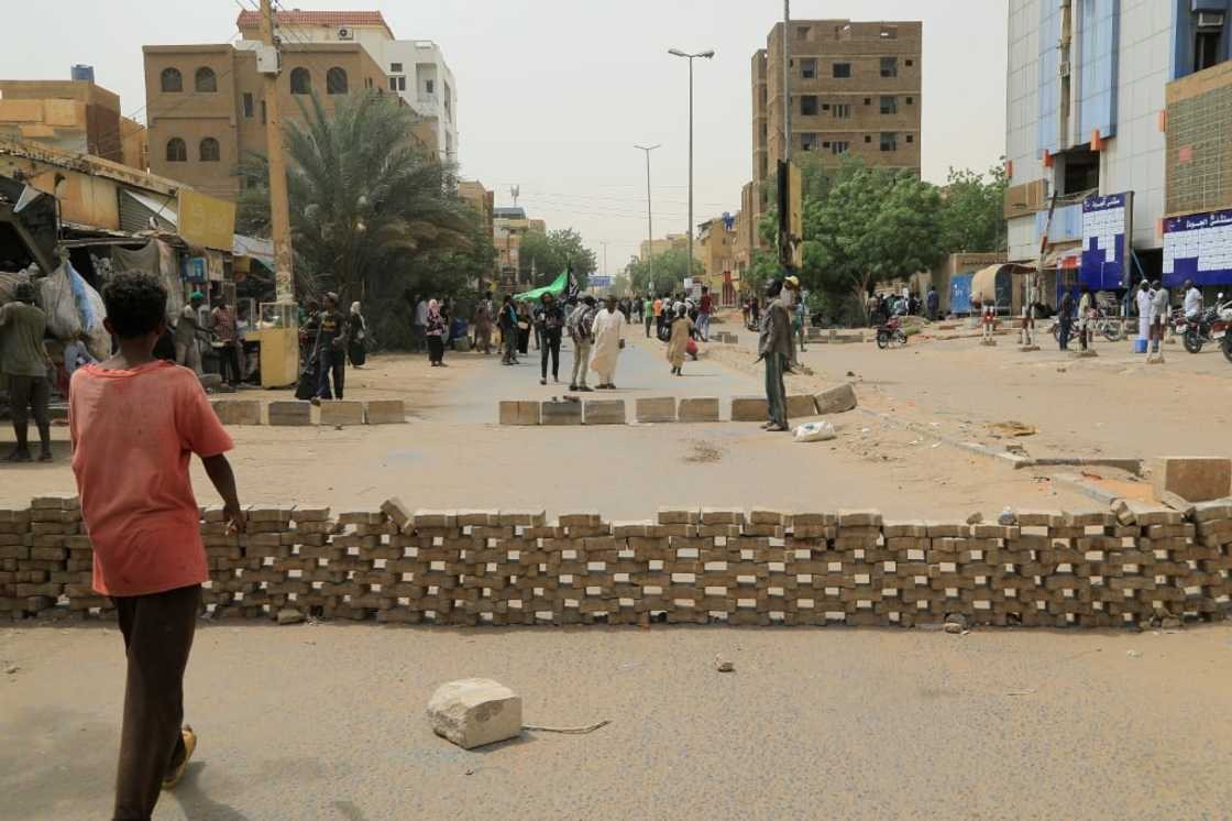 Sudanese anti-coup protesters gather on a blockaded street during a sit-in outside al-Jawda hospital in the capital Khartoum Sudanese anti-coup protesters gather on a blockaded street during a sit-in outside al-Jawda hospital in the capital Khartoum