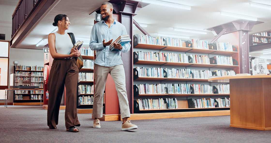 A couple walking past a library