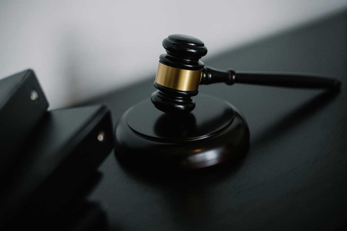 A close-up photo of a black wooden gavel with a gold ring