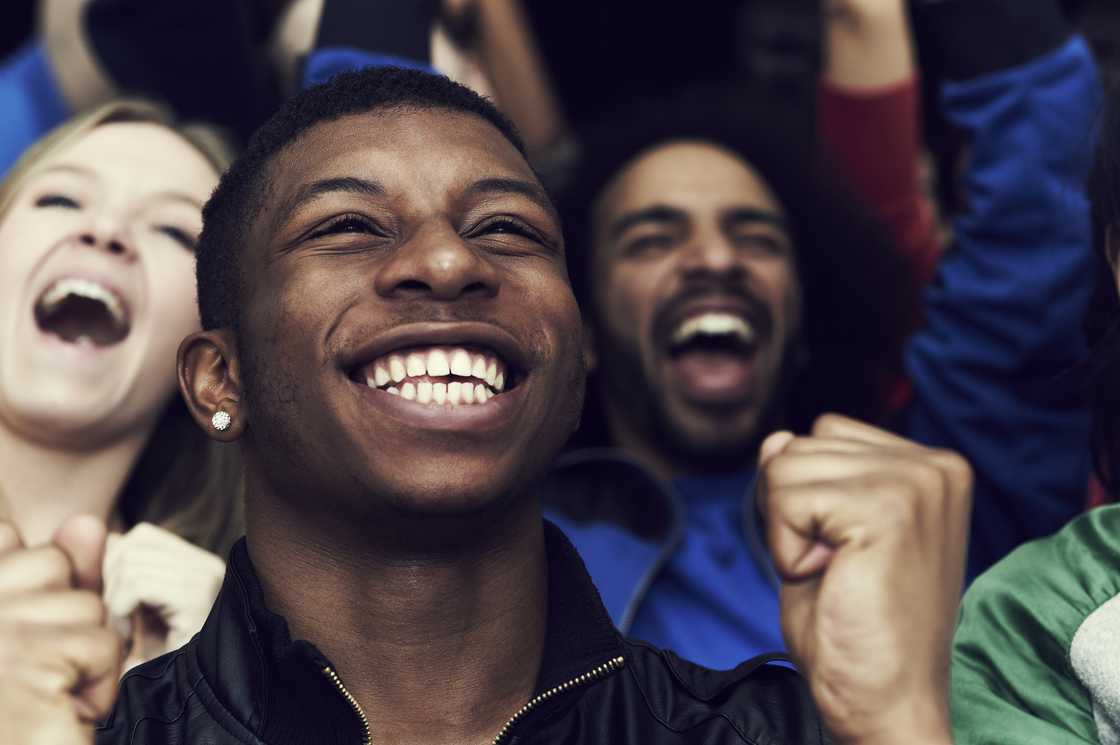 Soccer fans shouting in a viewing hall