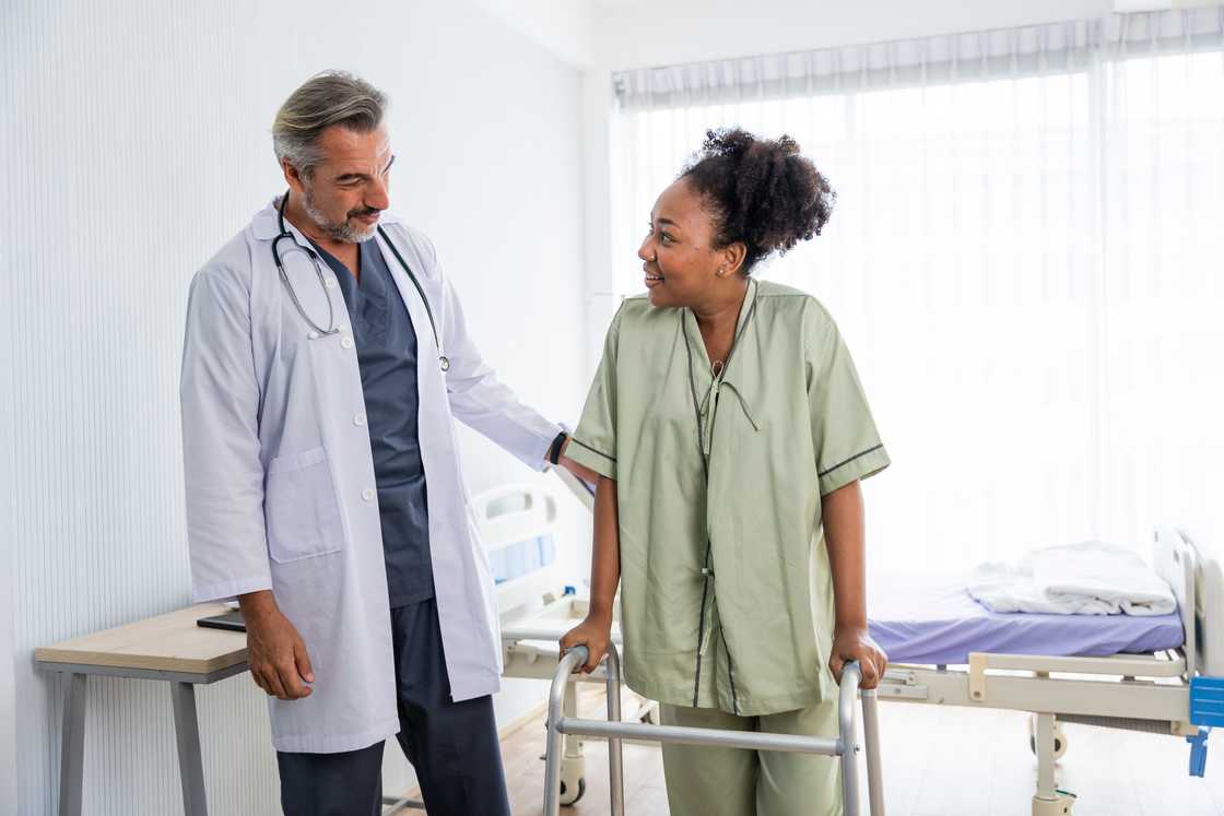 A young black woman patient takes her first steps