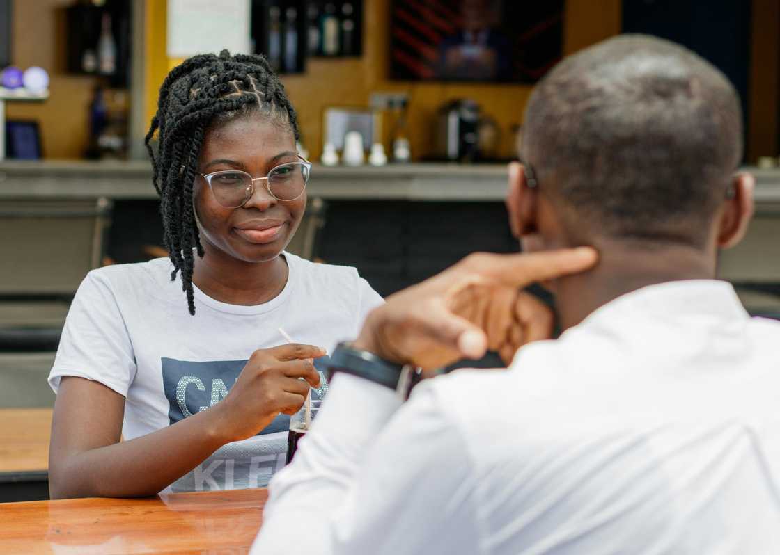 A lady and man at a cafe talking