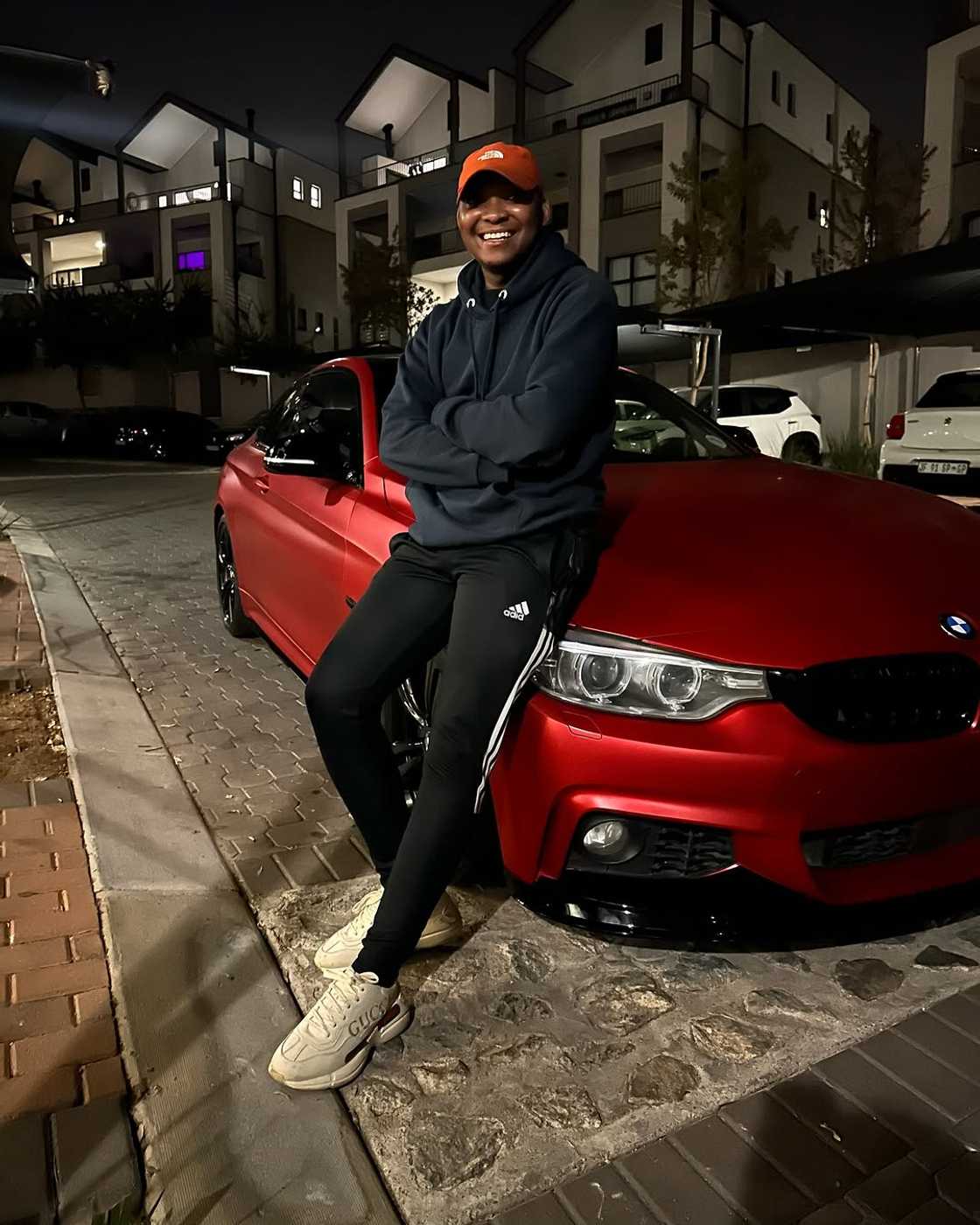 Man standing in front of a posh car.