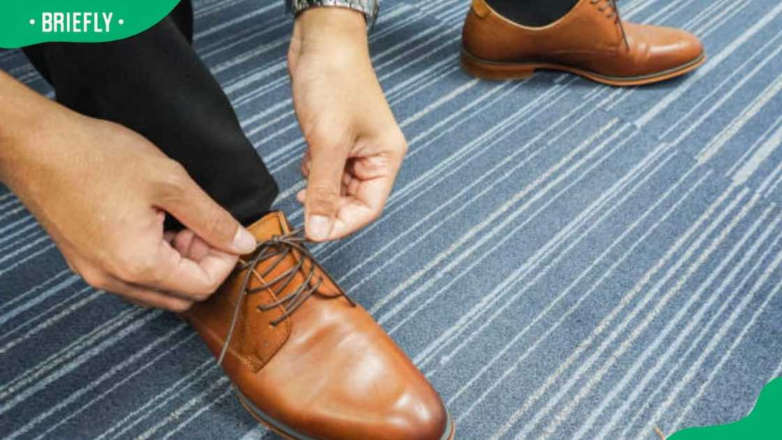 A man lace his shoes A man lace his shoes