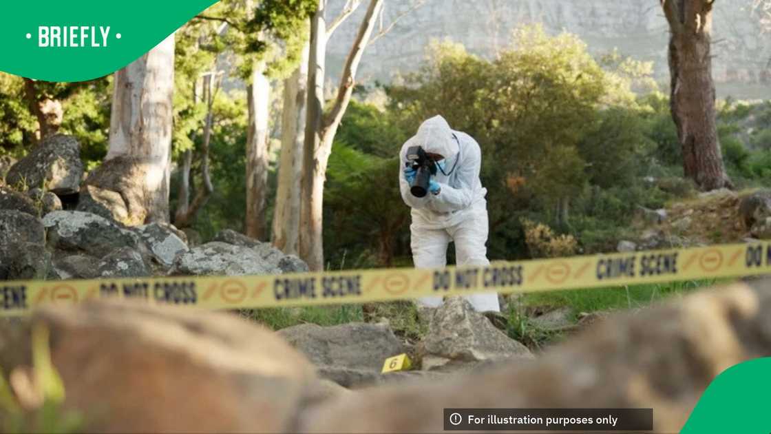 A picture of a CSI member taking photos of a crime scene A picture of a CSI member taking photos of a crime scene