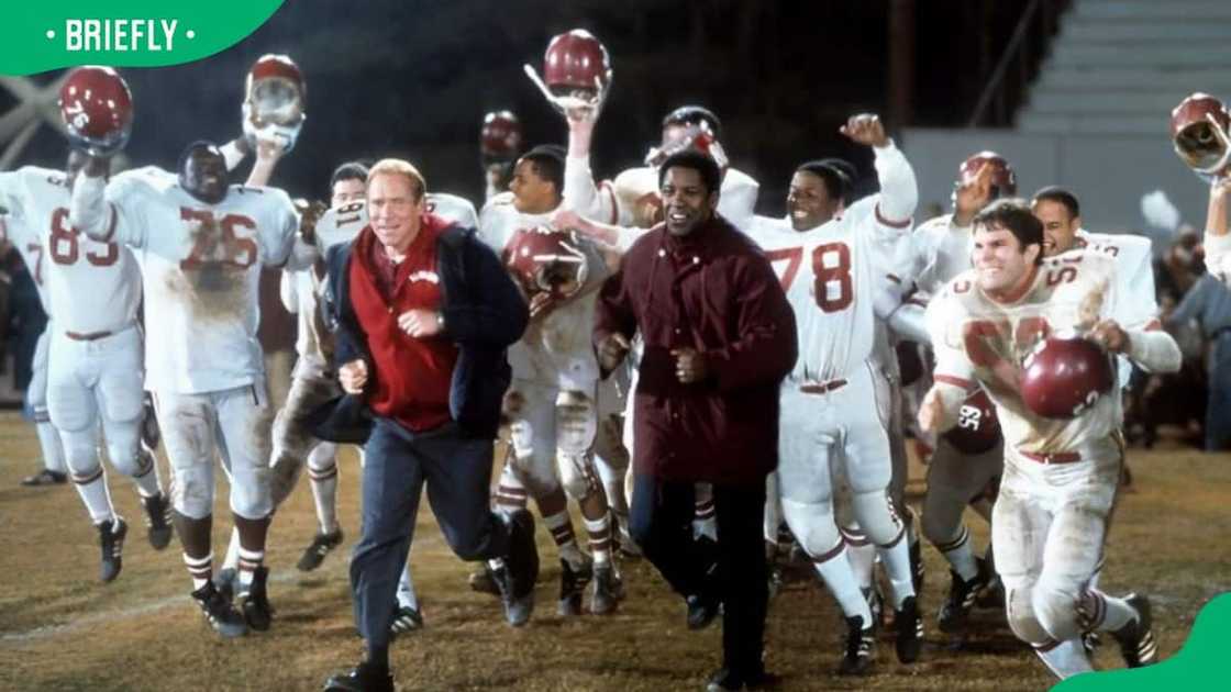 Will Patton and Denzel Washington running out onto the field in a scene from Remember The Titans in 2000 Will Patton and Denzel Washington running out onto the field in a scene from Remember The Titans in 2000