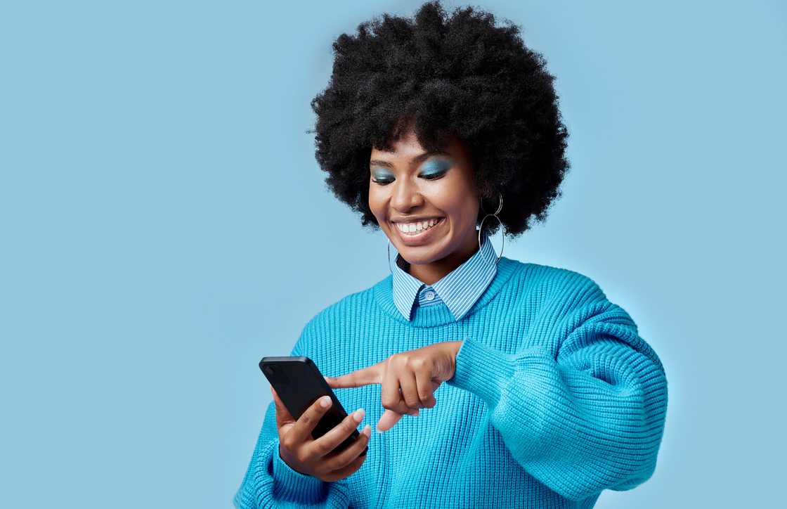 A young woman using a phone. A young woman using a phone.