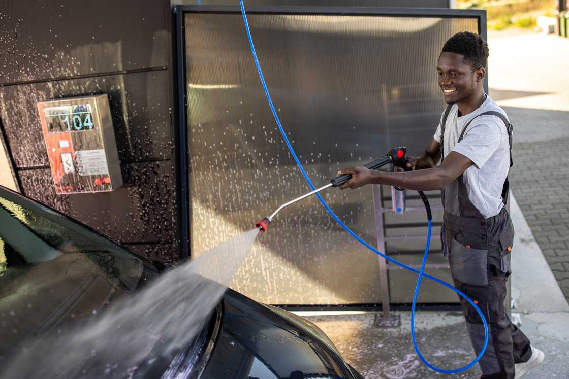 A man washing cars in the car wash
