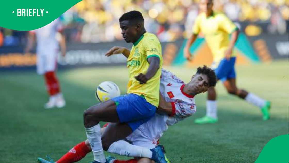 Teboho Mokoena battling for possession with an opponent during an intense moment in the African Champions League, showcasing determination and strength on the field