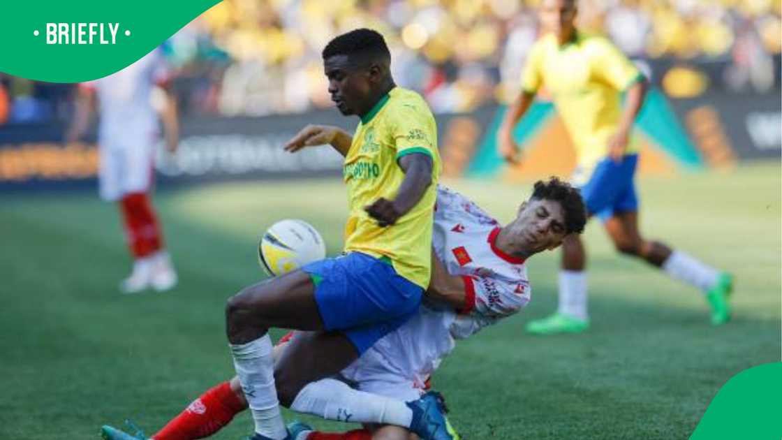 Teboho Mokoena battling for possession with an opponent during an intense moment in the African Champions League, showcasing determination and strength on the field Teboho Mokoena battling for possession with an opponent during an intense moment in the African Champions League, showcasing determination and strength on the field