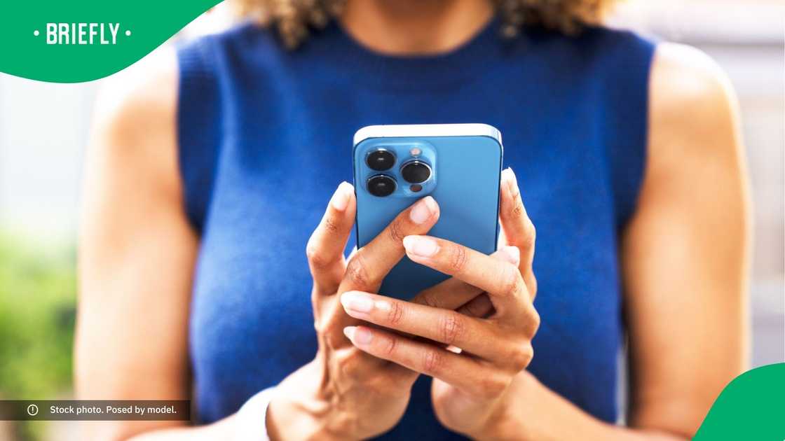 A woman typing on her phone.