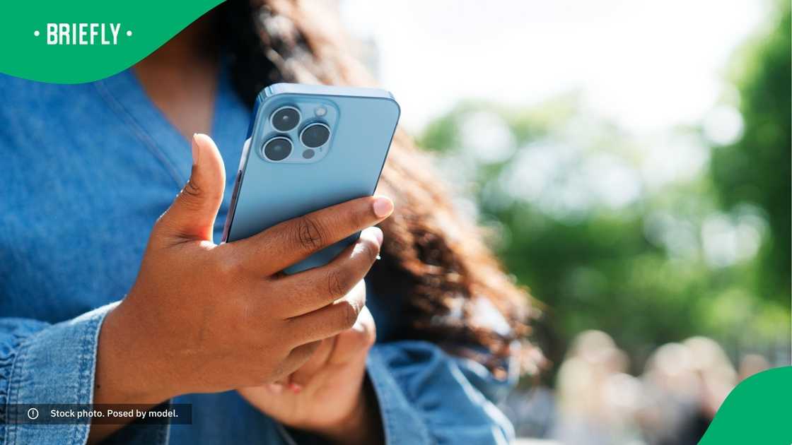 A woman typing on her phone.