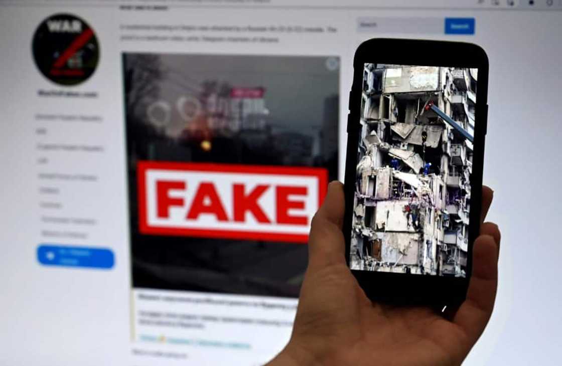A phone screen displaying a residential building in eastern Ukraine that was destroyed by a Russian missile A phone screen displaying a residential building in eastern Ukraine that was destroyed by a Russian missile