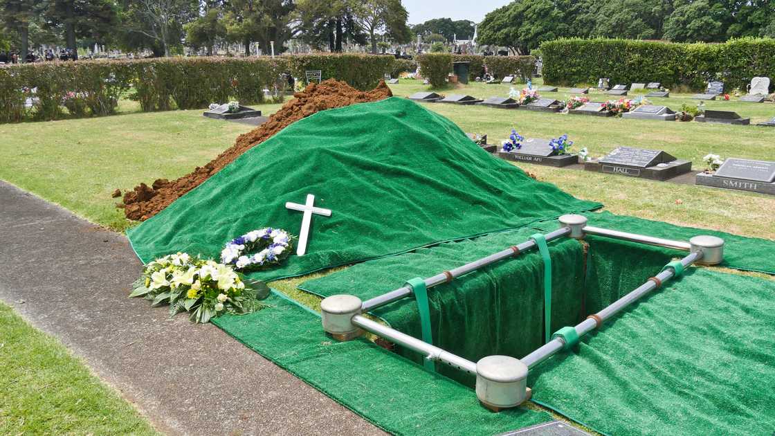 Freshly prepared burial site with green-lined grave. Freshly prepared burial site with green-lined grave.