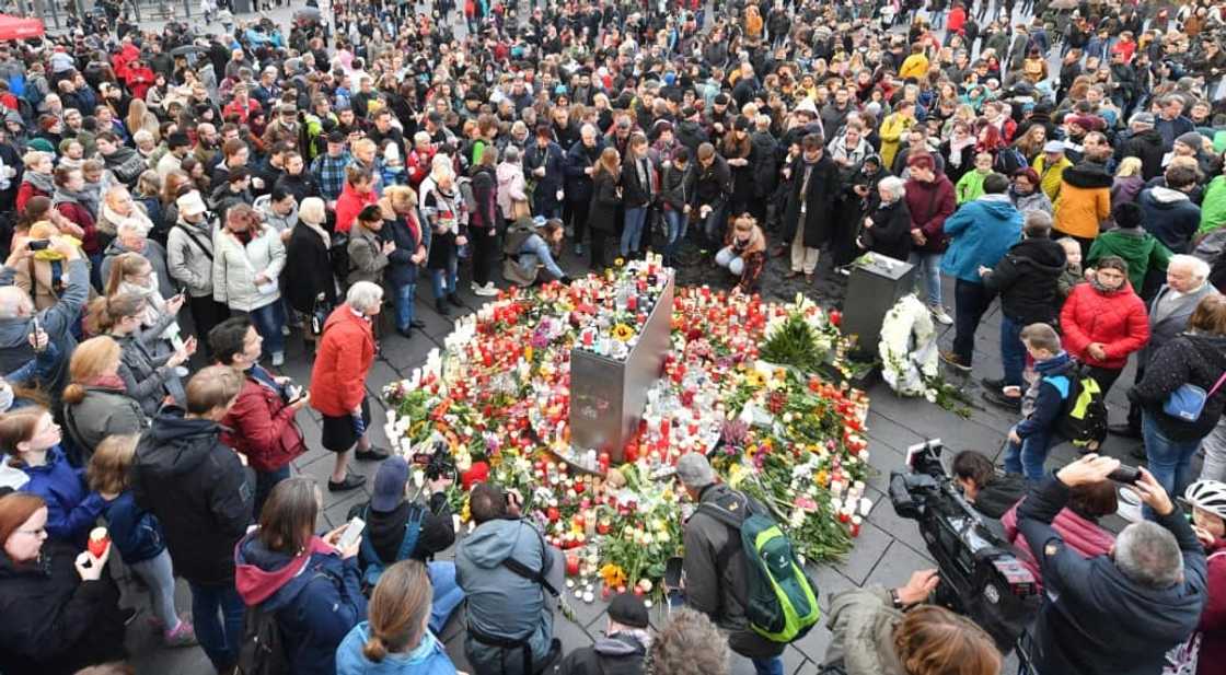 Mourners gather after a gunman killed two people with a 3D-printed weapon in Germany in 2019