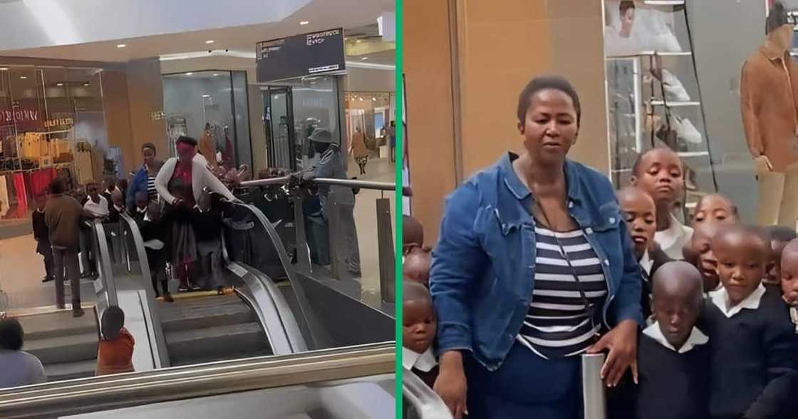 Teacher and schoolchildren waiting at the top of an escalator in a mall.