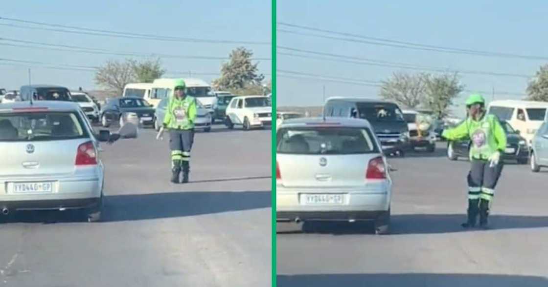 A woman directing traffic was given flowers A woman directing traffic was given flowers