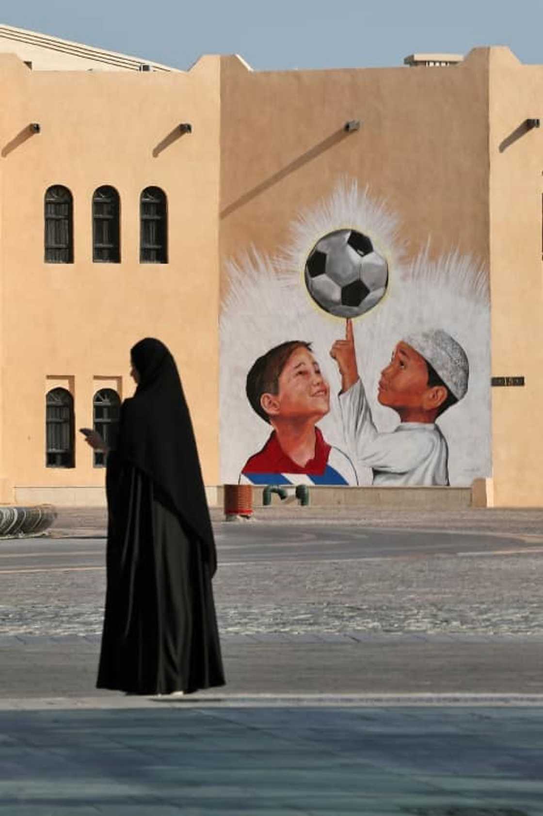 A woman walks past a mural in the Katara Cultural Village, in Qatar's capital Doha, on October 11, 2022 ahead of the FIFA 2022 football World Cup A woman walks past a mural in the Katara Cultural Village, in Qatar's capital Doha, on October 11, 2022 ahead of the FIFA 2022 football World Cup