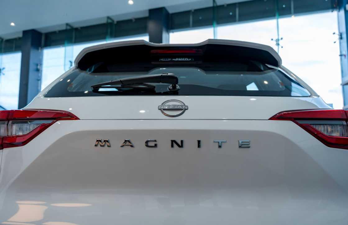 A Nissan car parked inside a delearship A Nissan car parked inside a delearship