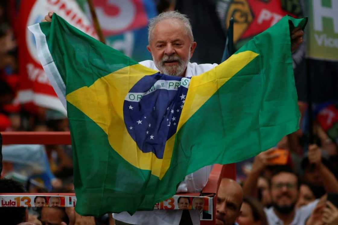 Brazil's former president Luiz Inacio Lula da Silva holds a Brazilian national flag during a re-election campaign rally in Guarulhos, Sao Paulo state, Brazil in October  2022 Brazil's former president Luiz Inacio Lula da Silva holds a Brazilian national flag during a re-election campaign rally in Guarulhos, Sao Paulo state, Brazil in October  2022
