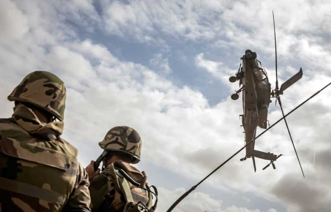 A US army AH-64 Apache attack helicopter flies over members of the Moroccan Royal Armed Forces during the second annual "African Lion" military exercise  on June 30 A US army AH-64 Apache attack helicopter flies over members of the Moroccan Royal Armed Forces during the second annual "African Lion" military exercise  on June 30
