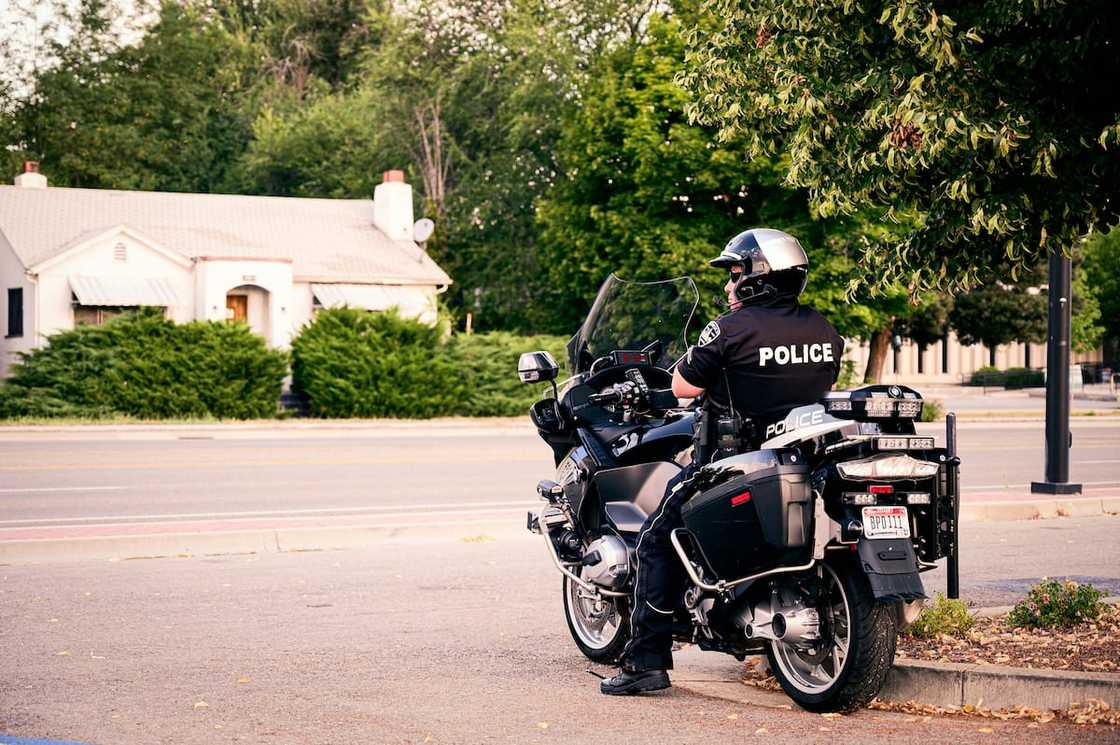 A traffic police officer on a motorcycle at a junction A traffic police officer on a motorcycle at a junction